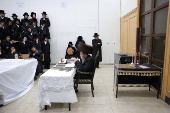 Ultra Orthodox Jews light Hanukkah holiday candles in Jerusalem