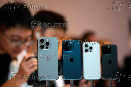 FILE PHOTO: People look at the new iPhone 15 Pro as Apple's new iPhone 15 officially goes on sale across China at an Apple store in Shanghai
