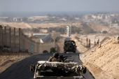 Israeli military vehicles drive through the Philadelphi Corridor area in southern Gaza