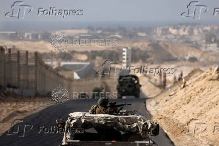 Israeli military vehicles drive through the Philadelphi Corridor area in southern Gaza