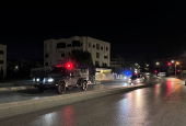 Police vehicles on a street near the Israeli embassy in Amman