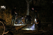 Israeli emergency services work at the scene of a missile strike, in Jaffa, south of Tel Aviv