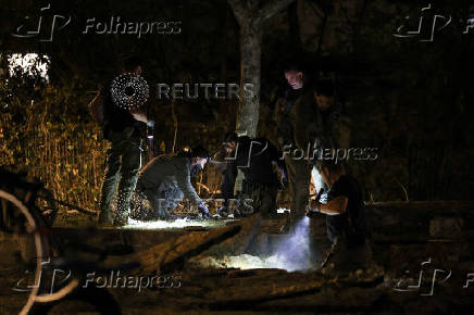 Israeli emergency services work at the scene of a missile strike, in Jaffa, south of Tel Aviv