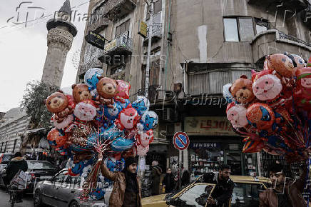 Men sell balloons, after Syria's Bashar al-Assad was ousted, at the downtown of Damascus