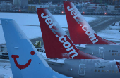 Snow is seen on the tails of aircraft after overnight snowfall caused the temporary closure of Manchester Airport in Manchester