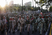 Members of the Bolivarian Militia and supporters of President Nicolas Maduro march to plead allegiance