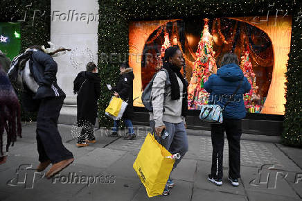 Shoppers walk on Oxford Street in London