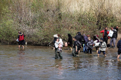 Alawite Syrians, who fled the violence in western Syria, walk at the water of Nahr El Kabir, in Akkar