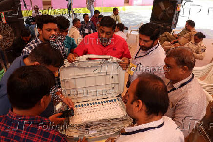 FILE PHOTO: Election staff scan serial numbers of Electronic Voting Machines (EVM) before dispatching them from a warehouse ahead of India's general election in Ahmedabad