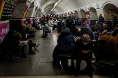 People take shelter inside a metro station during a Russian missile strike in Kyiv