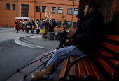 People dressed in traditional clothes sing carols for injured service members in Kyiv