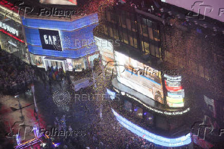 People gather at Times Square to watch the ball drop on New Year's Eve in New York City