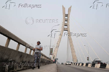 A woman jogs along the Lekki-Ikoyi Link Bridge in Lagos