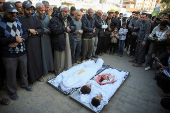 Palestinians mourn loved ones killed in Israeli strikes, in Khan Younis in the southern Gaza Strip