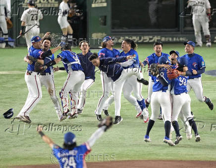 Taiwan team members celebrate winning the WBSC Premier12 baseball tournament at the final game against Japan, in Tokyo