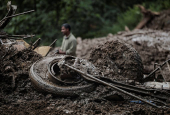 Rescue personnel work to retrieve the bodies of victims from a landslide triggered by heavy rainfall, in Dhading