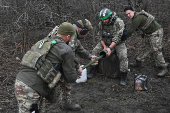 Policemen of the 'Khyzhak' Brigade clean a mortar after firing towards Russian troops at their position in a front line near the town of Toretsk