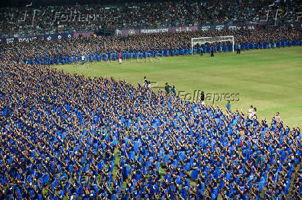 Participants wearing colourful attire, perform Bharatanatyam dance at the Jawaharlal Nehru International Stadium, in Kochi