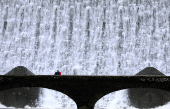 Water flows over the Caban Coch Dam in the Elan Valley