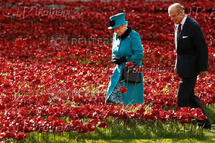 FILE PHOTO: Britain's Queen Elizabeth and Prince Philip walk through a field of ceramic poppies that form part of the art installation 