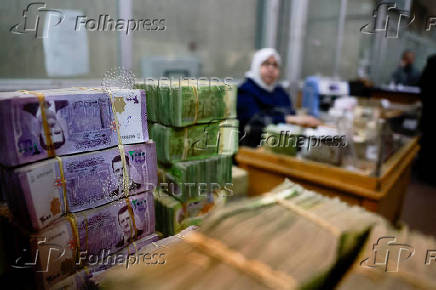 Bundles of Syrian currency notes are stacked up at Syrian central bank in Damascus