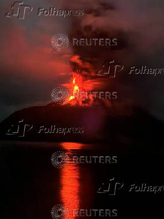 Mount Ruangvolcanospews volcanic ash as seen from Siau Tagulandang Biaro