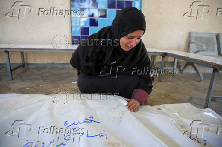 Palestinians mourn loved ones killed in Israeli strikes, in Khan Younis in the southern Gaza Strip