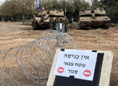 Israeli soldiers gather by tanks in the Israeli-occupied Golan Heights near the border with Syria