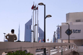 FILE PHOTO: A person runs outside the Dubai Financial Market building in Dubai,