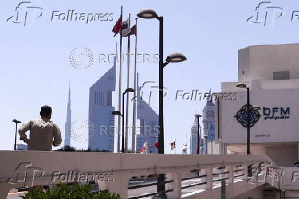 FILE PHOTO: A person runs outside the Dubai Financial Market building in Dubai,