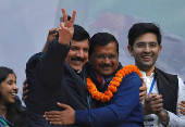 FILE PHOTO: Arvind Kejriwal is greeted by Sanjay Singh as Raghav Chadha looks on at the party headquarters in New Delhi