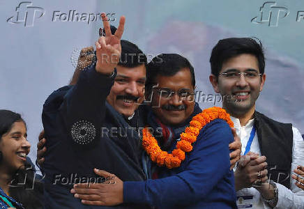 FILE PHOTO: Arvind Kejriwal is greeted by Sanjay Singh as Raghav Chadha looks on at the party headquarters in New Delhi