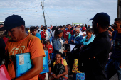 Venezuelans queue to get documentation after leaving Venezuela, at the border, in Pacaraima