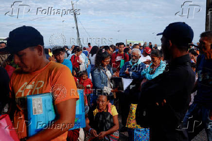 Venezuelans queue to get documentation after leaving Venezuela, at the border, in Pacaraima