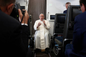 FILE PHOTO: Pope Francis holds a news conference aboard the papal plane