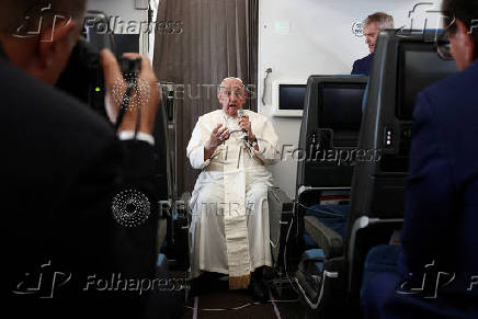 FILE PHOTO: Pope Francis holds a news conference aboard the papal plane