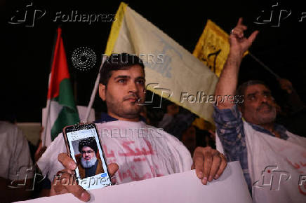 People protest following an Israeli strike on Lebanon, in Tehran