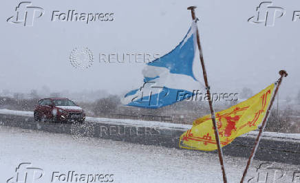 A car drives through the Drumochter pass on the A9, Scotland