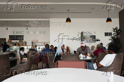 Customers sit inside a bakery in Lagos