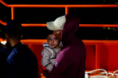 Migrants wait to disembark from a Spanish coast guard vessel, in the port of Arguineguin, on the island of Gran Canaria