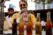 A visitor looks on as he carries his baby at the Dubai Taste festival as food enthusiasts and international chefs get together for a weekend of culinary activities in Dubai