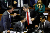 Senator Flavio Bolsonaro greets Senator Randolfe Rodrigues during a session of the National Congress at the plenary chamber of deputies in Brasilia