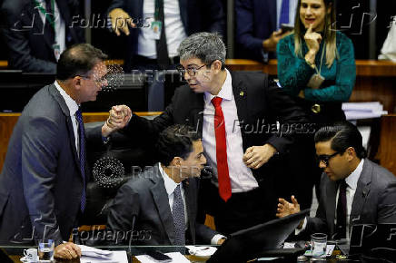 Senator Flavio Bolsonaro greets Senator Randolfe Rodrigues during a session of the National Congress at the plenary chamber of deputies in Brasilia