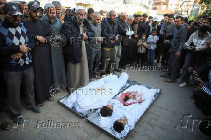 Palestinians mourn loved ones killed in Israeli strikes, in Khan Younis in the southern Gaza Strip