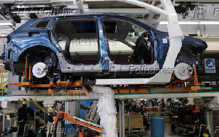 FILE PHOTO: An employee works on the production line of the Volkswagen Tiguan cars at the company's assembly plant in Puebla,