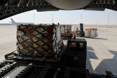 Qatari aid being loaded onto a military cargo plane headed to Syria through Turkey