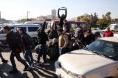 People gather in Umayyad Square after Syria's Bashar al-Assad was ousted in central Damascus