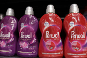 Perwoll products are displayed on a shelf in a supermarket