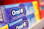 Oral-B products are displayed on a shelf in a supermarket