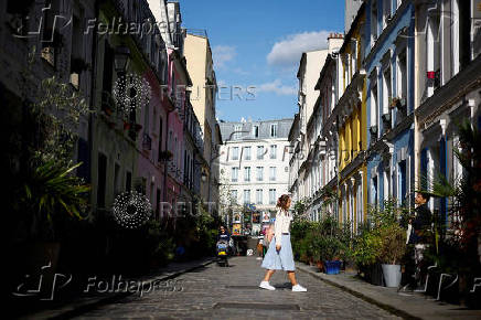 FILE PHOTO: People walk in Rue Cremieux in Paris